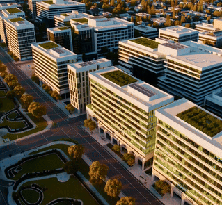Aerial view of modern office buildings in a business district, showcasing sleek architecture and green rooftop spaces.